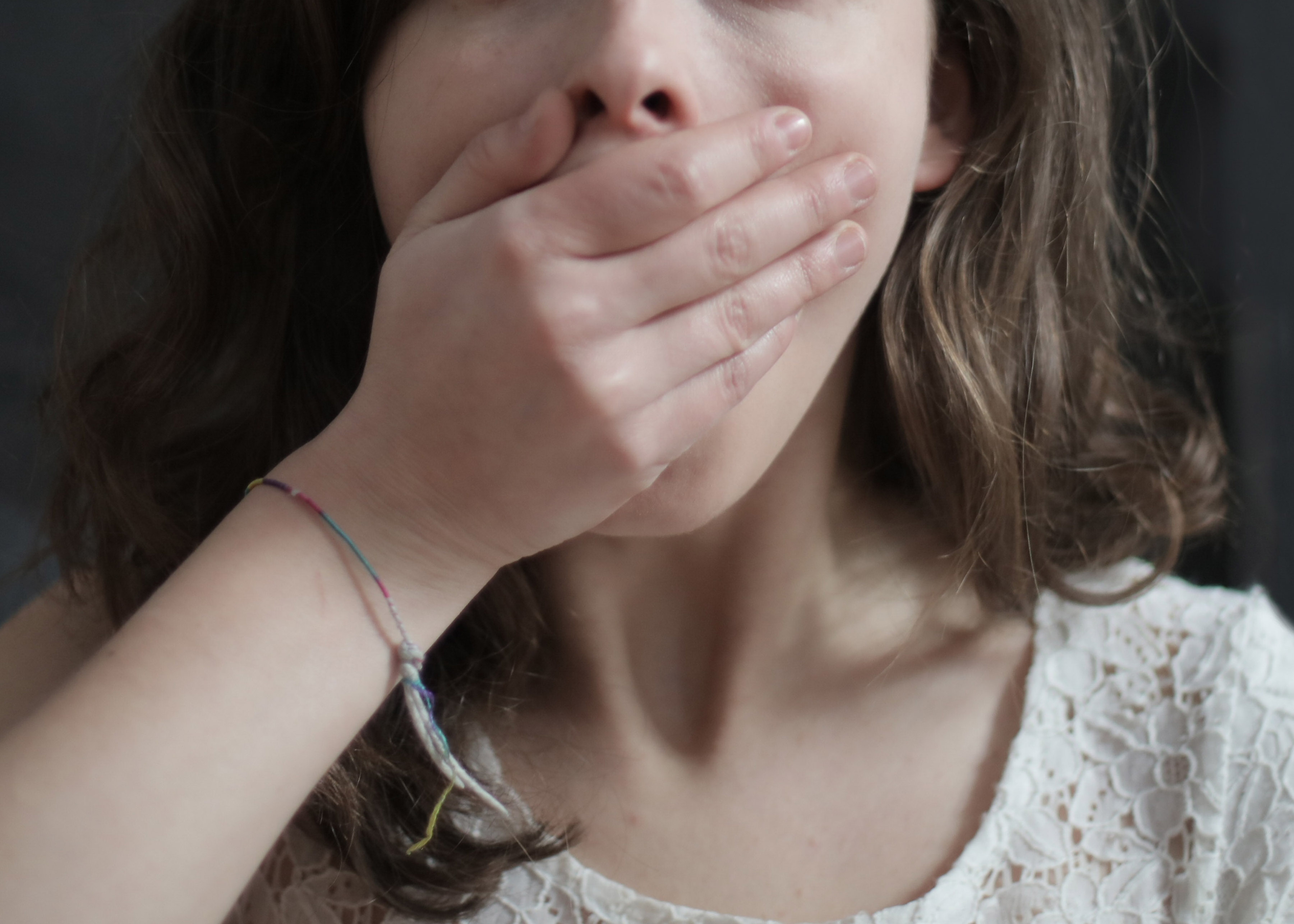 white girl covering mouth with hand